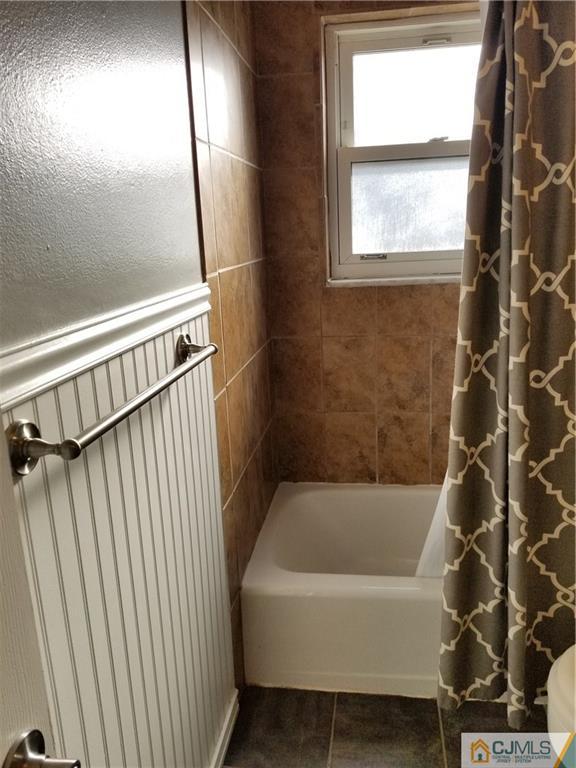 197 Evergreen Road, Unit 3B Edison, NJ 08837 - Photo 18 of 20 a bathroom with a bathtub and a shower
