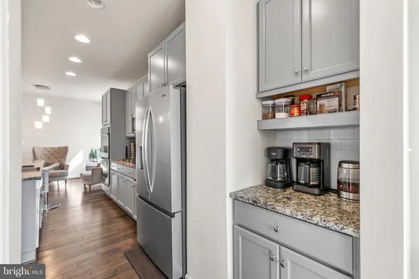 a kitchen with refrigerator and cabinets