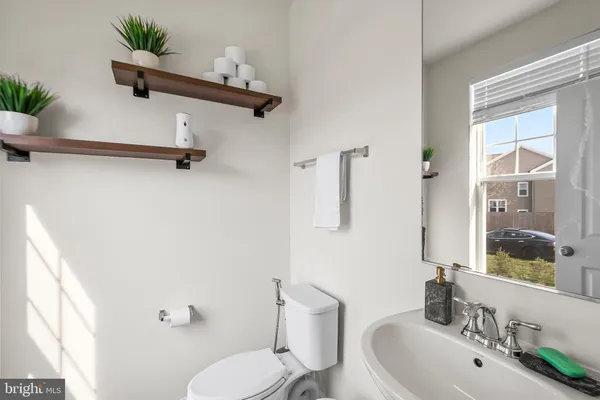 a bathroom with a sink mirror and toilet