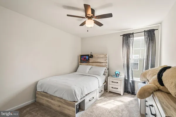 a bedroom with a bed and a large window