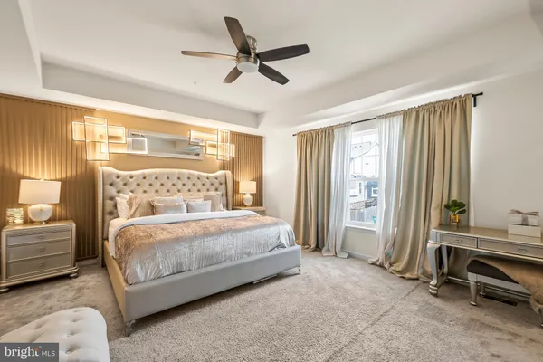 a bedroom with a bed and a ceiling fan