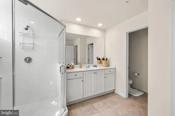 a bathroom with a double vanity sink mirror and shower