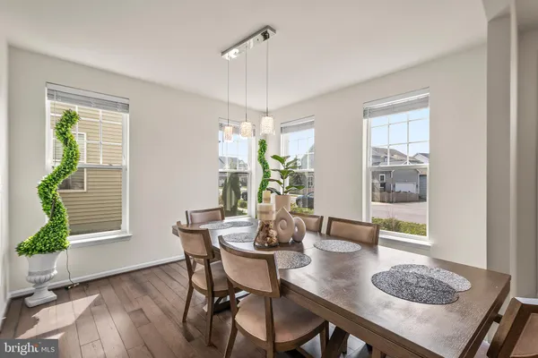 a dining room with furniture and wooden floor