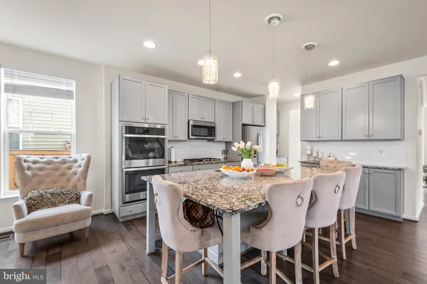 a kitchen with kitchen island granite countertop a center island and appliances