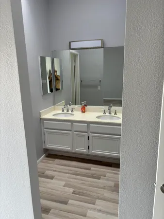 a bathroom with a sink mirror and