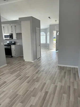 a kitchen with granite countertop a refrigerator and a stove