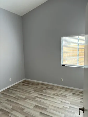 a view of a room with wooden floor and windows
