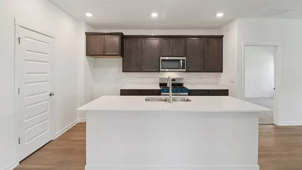 a kitchen with stainless steel appliances a refrigerator and microwave