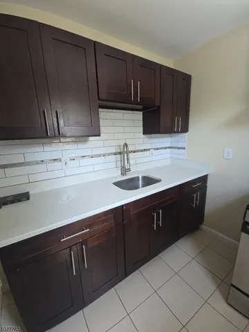 a kitchen with a sink and cabinets