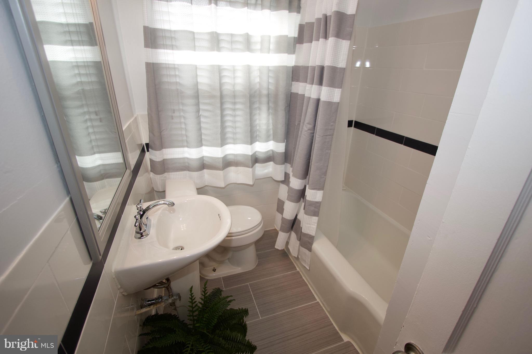 134 North Culver Street Baltimore, MD 21229 - Photo 20 of 30 a bathroom with a sink and a mirror