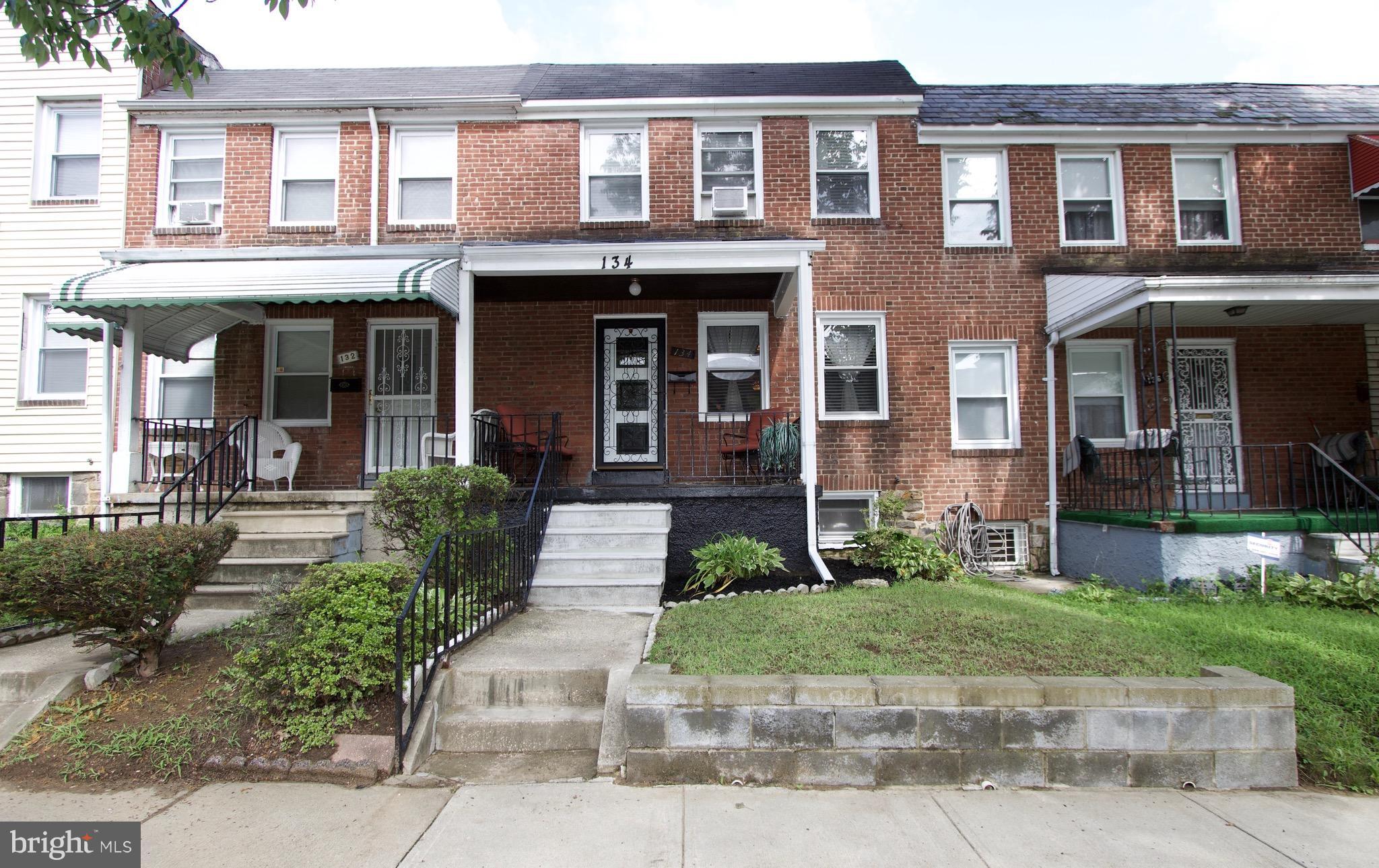 134 North Culver Street Baltimore, MD 21229 - Photo 30 of 30 a front view of a brick house with a yard