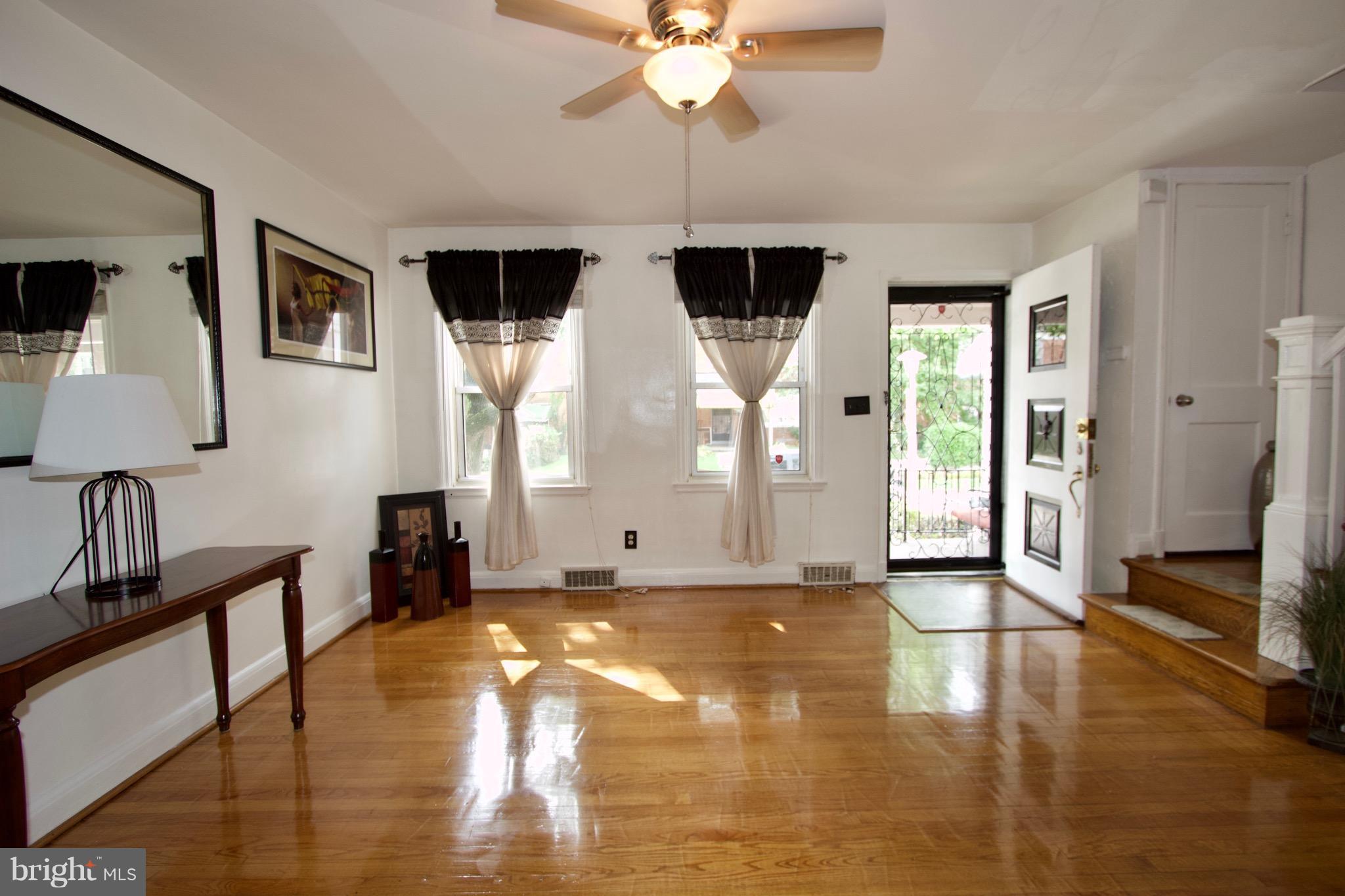 134 North Culver Street Baltimore, MD 21229 - Photo 6 of 30 a view of a livingroom with wooden floor and a ceiling fan