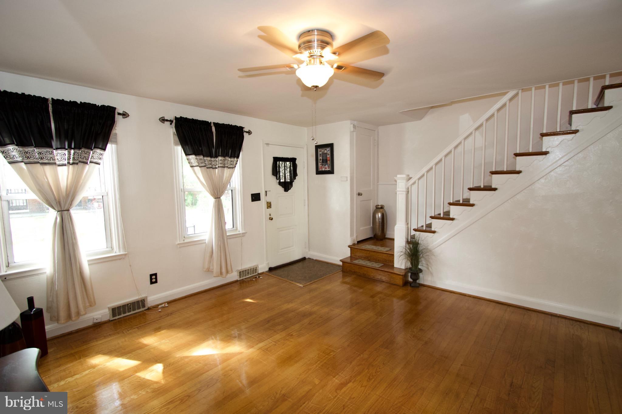 134 North Culver Street Baltimore, MD 21229 - Photo 7 of 30 a view of a livingroom with a ceiling fan and window