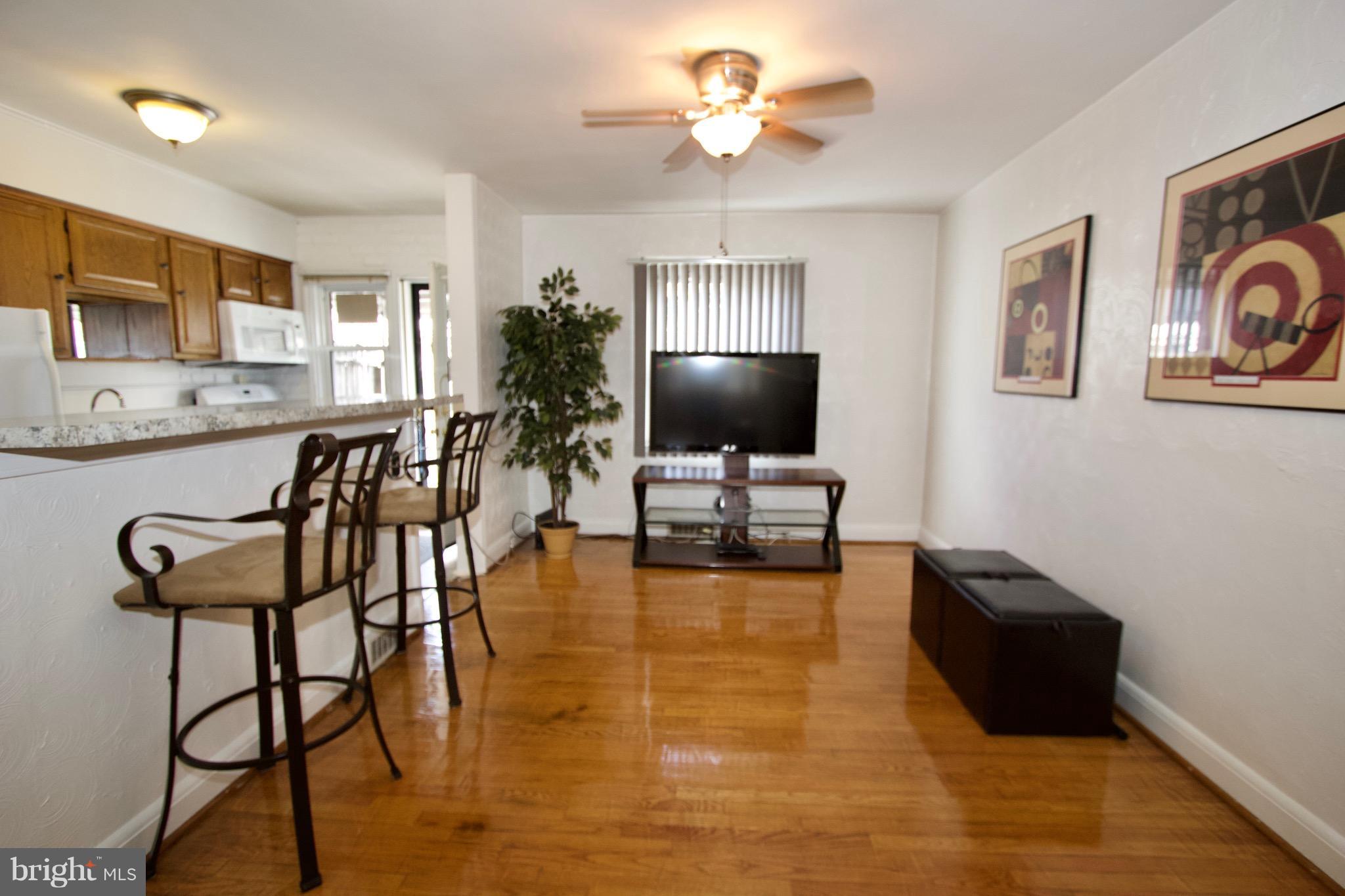 134 North Culver Street Baltimore, MD 21229 - Photo 10 of 30 a view of a livingroom with furniture and a flat screen tv