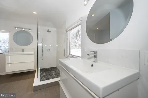 a bathroom with a sink a toilet and a mirror