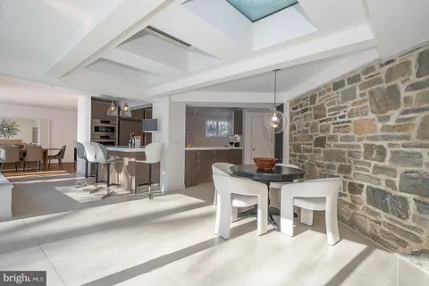 a living room with a sink and chairs