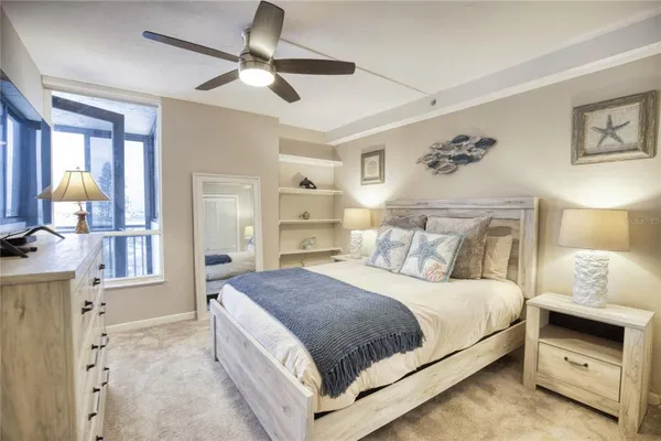 a bedroom with a large bed and a chandelier