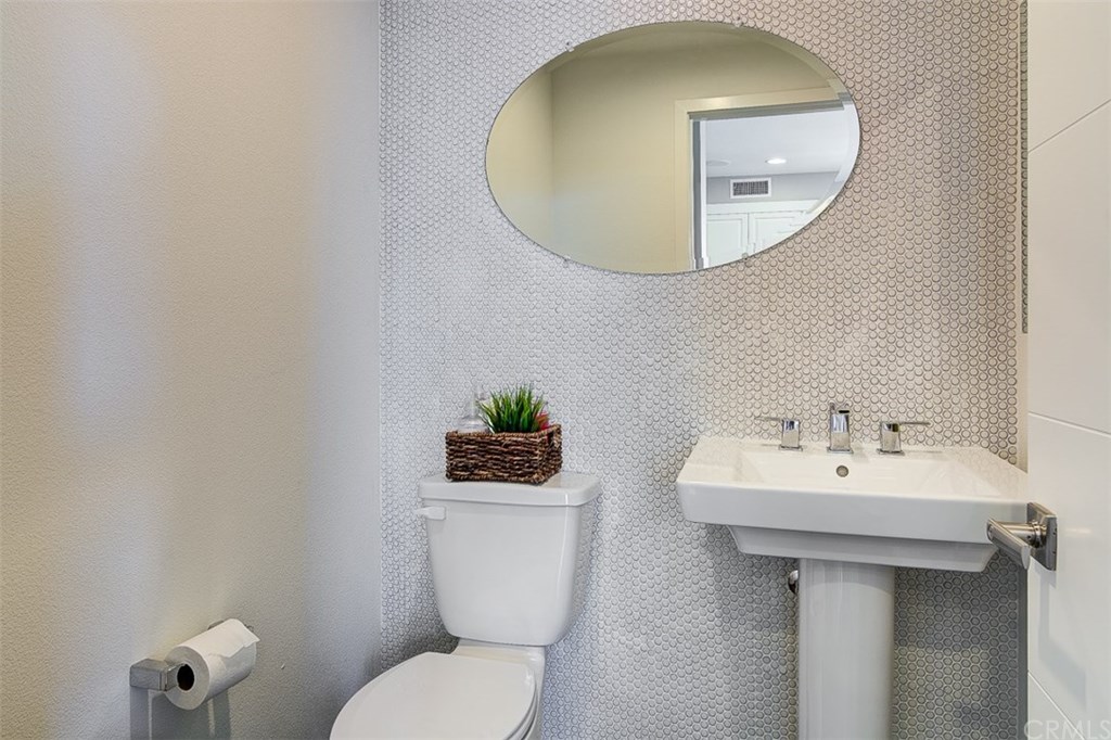 1678 Jetty Drive Costa Mesa, CA 92627 - Photo 36 of 72 a bathroom with a toilet sink and mirror