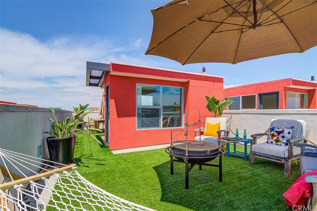 1678 Jetty Drive Costa Mesa, CA 92627 - Photo 62 of 72 a backyard of a house with table and chairs