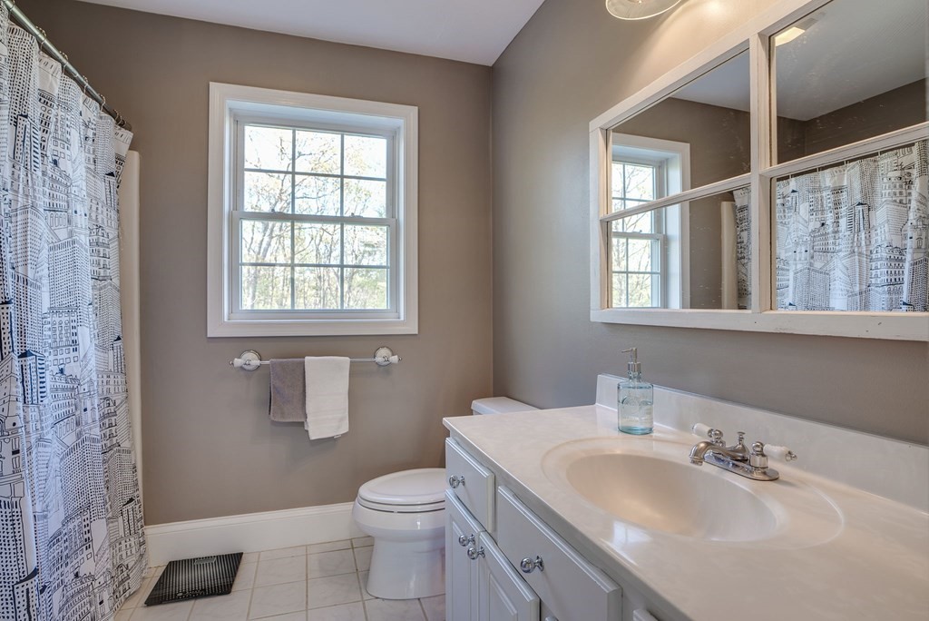 40 Partridge Road Windham, NH 03087 - Photo 33 of 42 a bathroom with a sink toilet and window