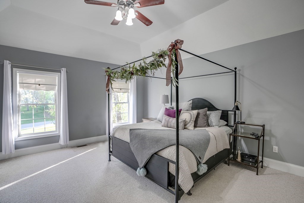 40 Partridge Road Windham, NH 03087 - Photo 36 of 42 a bedroom with a bed window and a chandelier