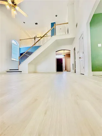 a view of a white building with a ceiling fan