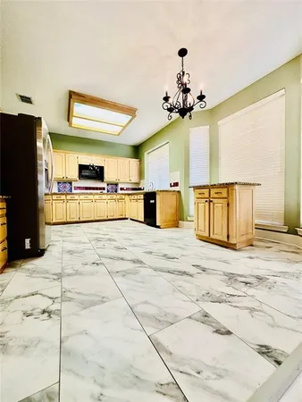 a view of a kitchen with a sink outdoor seating area