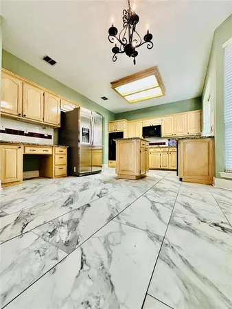 a kitchen with stainless steel appliances granite countertop a stove and a refrigerator