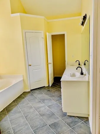 a bathroom with a granite countertop toilet sink and mirror
