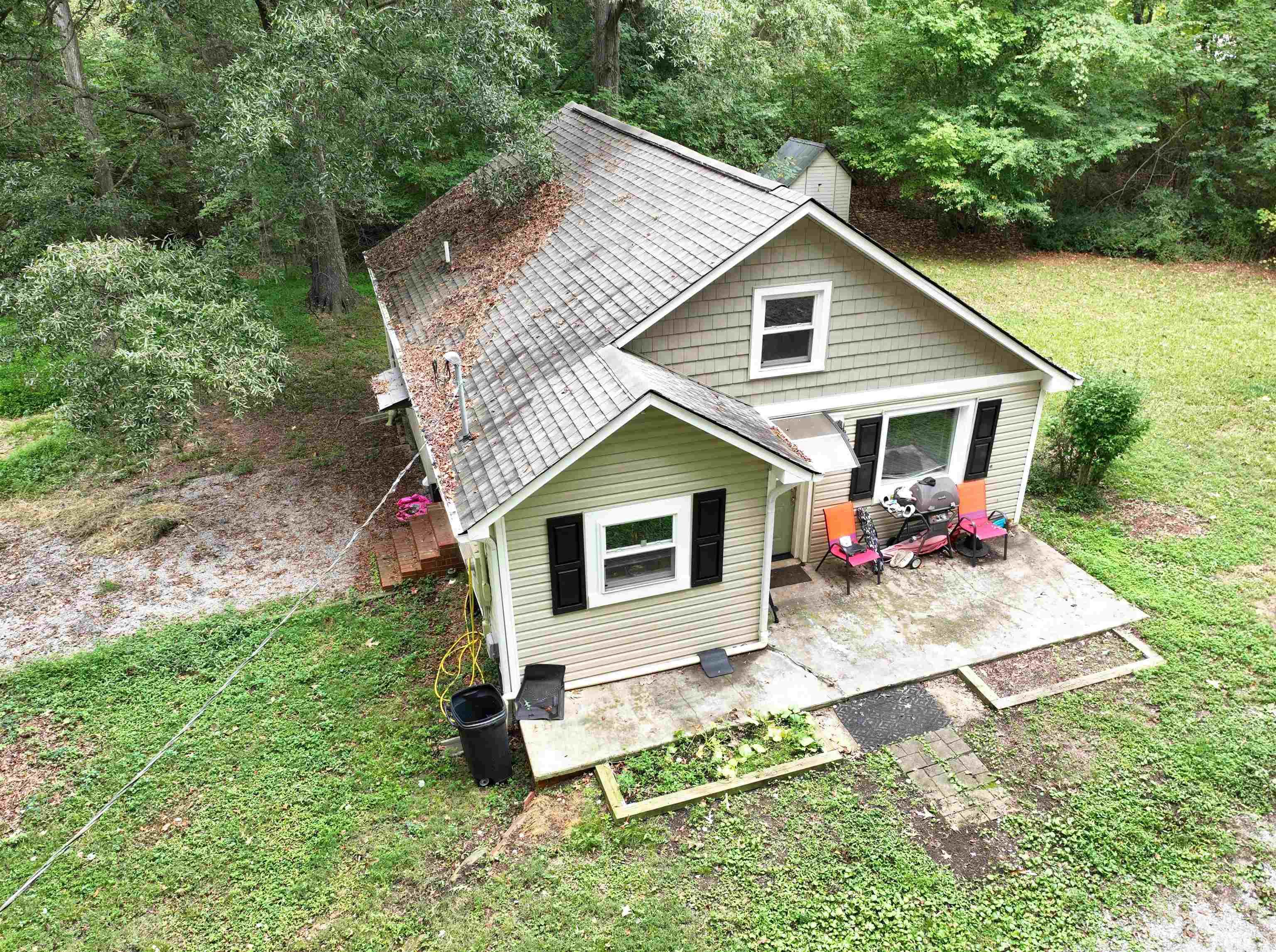 1539 Deep River Road Sanford, NC 27330 - Photo 14 of 34 a view of a house with a yard and lawn chairs with plants