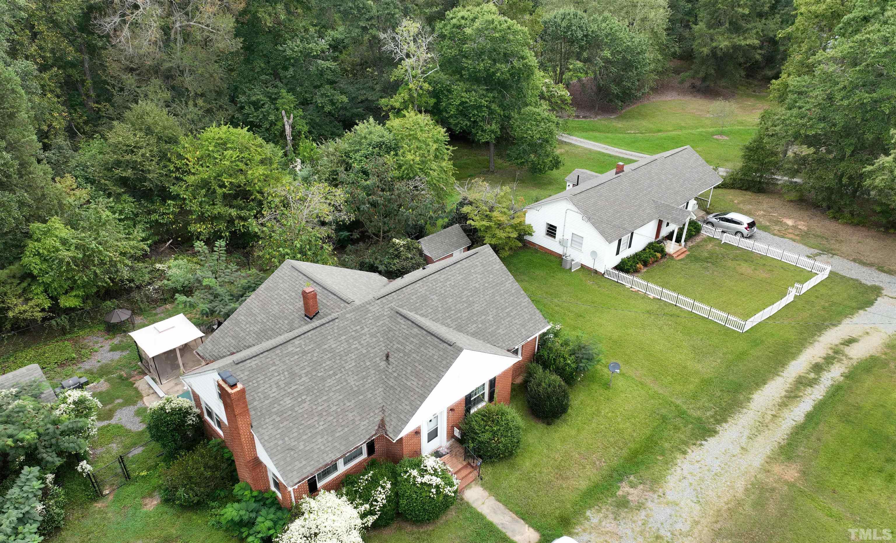 1539 Deep River Road Sanford, NC 27330 - Photo 20 of 34 an aerial view of a house with swimming pool and a yard