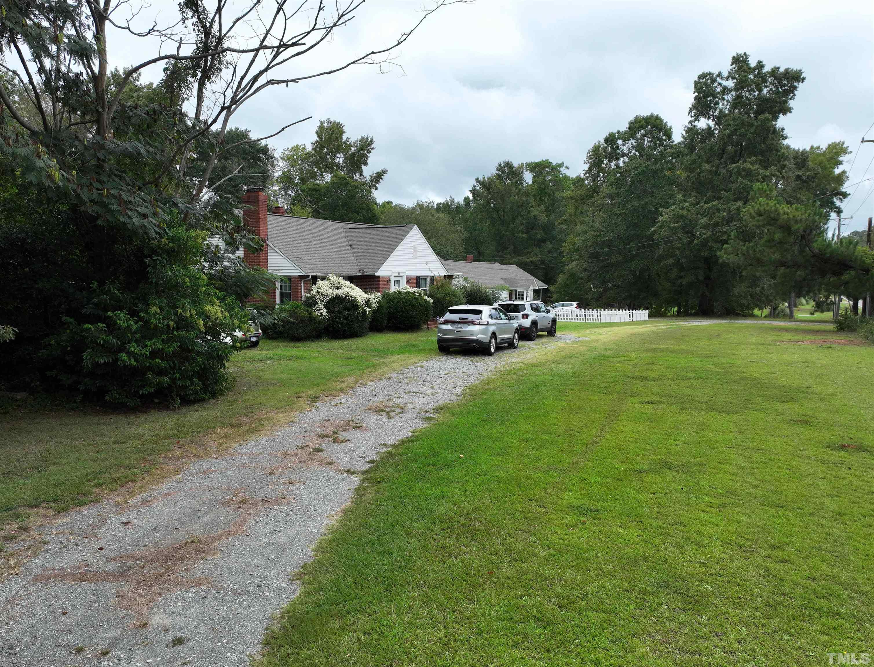 1539 Deep River Road Sanford, NC 27330 - Photo 7 of 34 a view of a park with plants and a bench