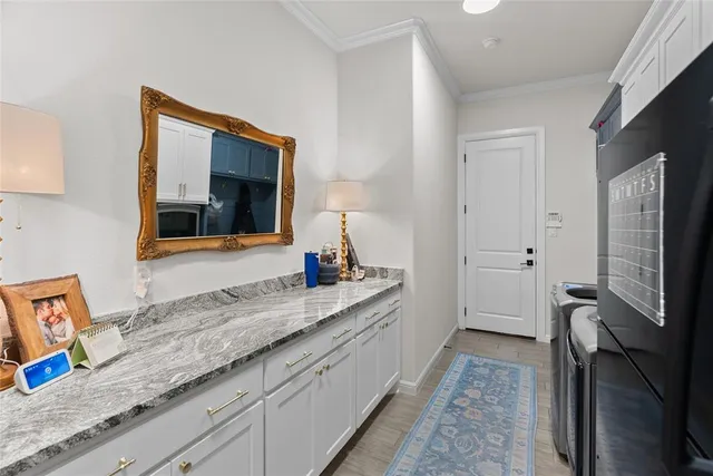 a en suite bathroom with a granite countertop sink and a large mirror