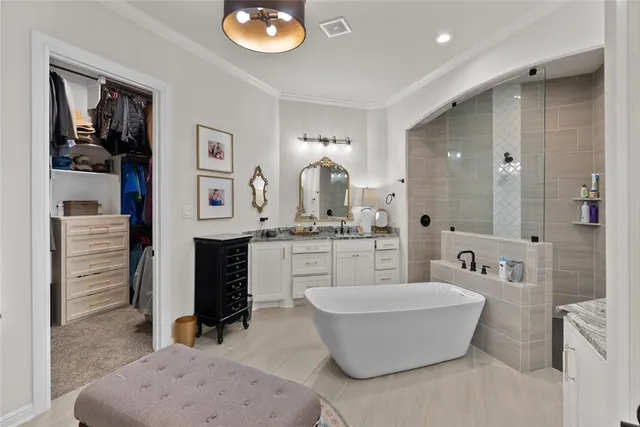 a spacious bathroom with a tub sink and mirror