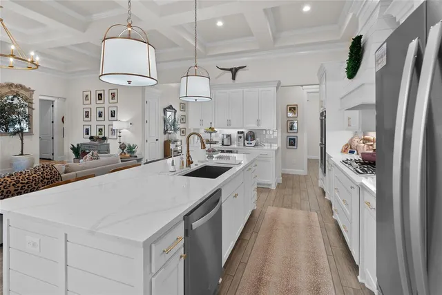 a kitchen with stainless steel appliances a sink stove and refrigerator