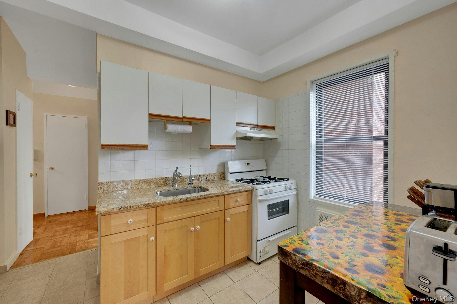 1 Remsen Road, Unit 1F Yonkers, NY 10710 - Photo 13 of 19 Eat in Kitchen with granite countertops, facing hallway.