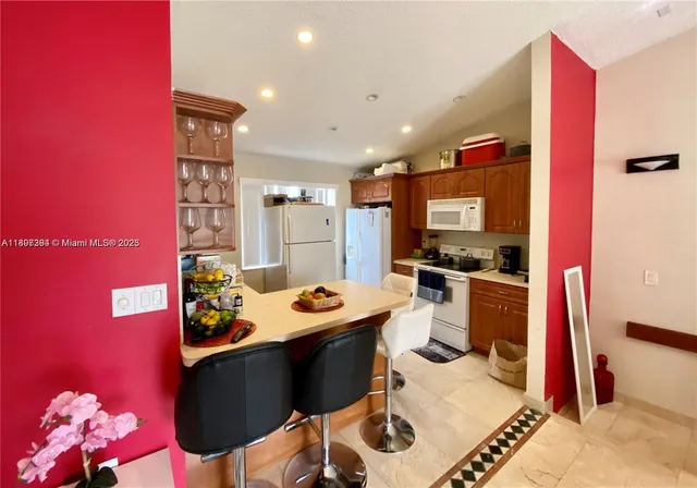a kitchen with granite countertop a sink and cabinets
