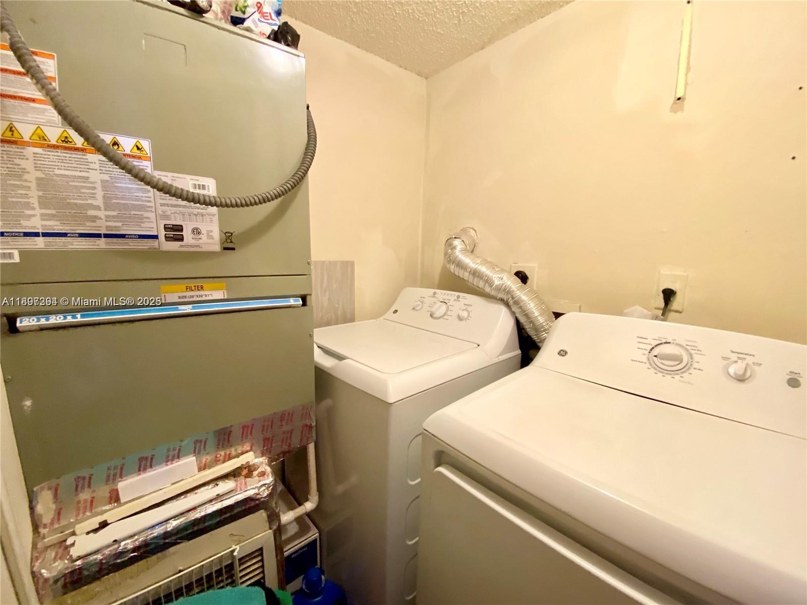 8039 Lake Drive, Unit 201 Doral, FL 33166 - Photo 9 of 9 a utility room with dryer and washer