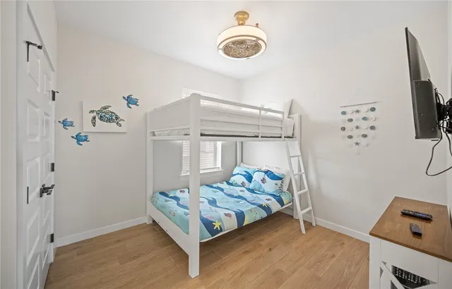 a bedroom with a bed and a chandelier