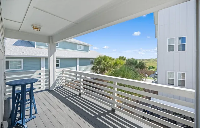 a view of a house with barbeque and wooden floor