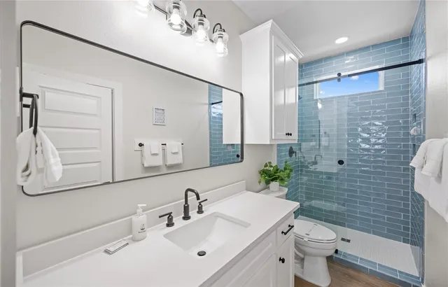 a bathroom with a sink toilet and shower