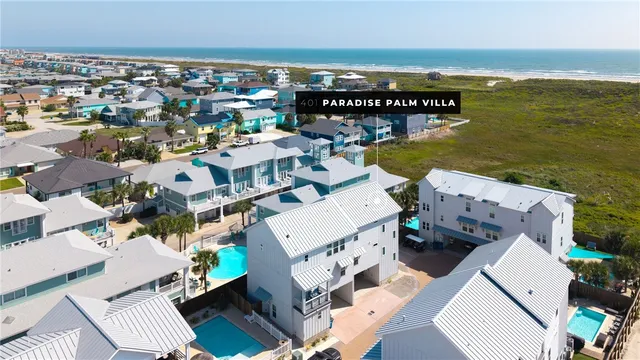 an aerial view of a house with ocean view