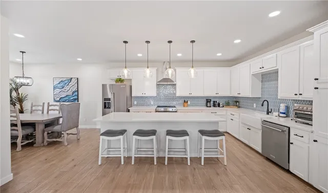 a large kitchen with a table and chairs