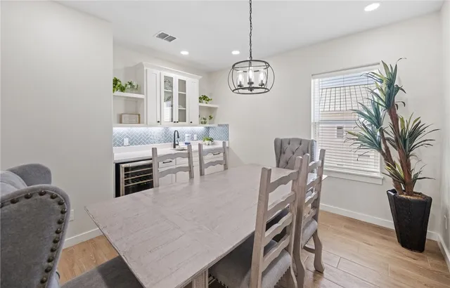 a view of a dining room with furniture wooden floor and chandelier