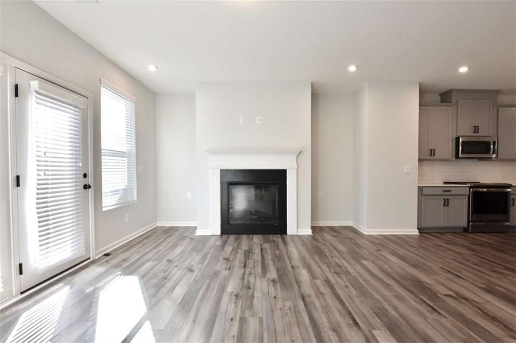 809 Cameron Trail Acworth, GA 30102 - Photo 11 of 38 a view of empty room with wooden floor and fireplace