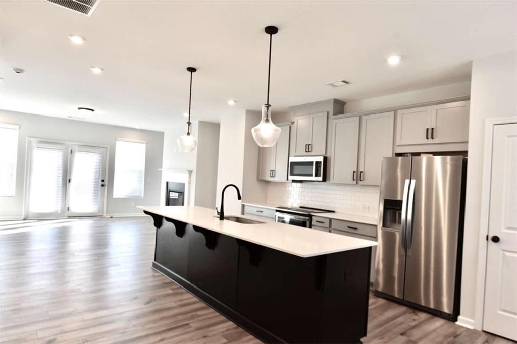 809 Cameron Trail Acworth, GA 30102 - Photo 14 of 38 a kitchen with stainless steel appliances a refrigerator a sink a center island and wooden floor