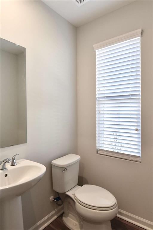 809 Cameron Trail Acworth, GA 30102 - Photo 17 of 38 a white toilet sitting next to a bathroom sink