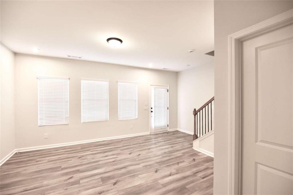 809 Cameron Trail Acworth, GA 30102 - Photo 33 of 38 a view of an empty room with wooden floor and a window