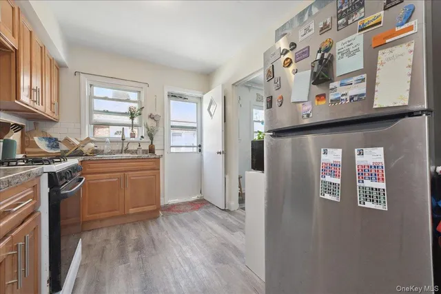 a kitchen with stainless steel appliances granite countertop a refrigerator and a sink