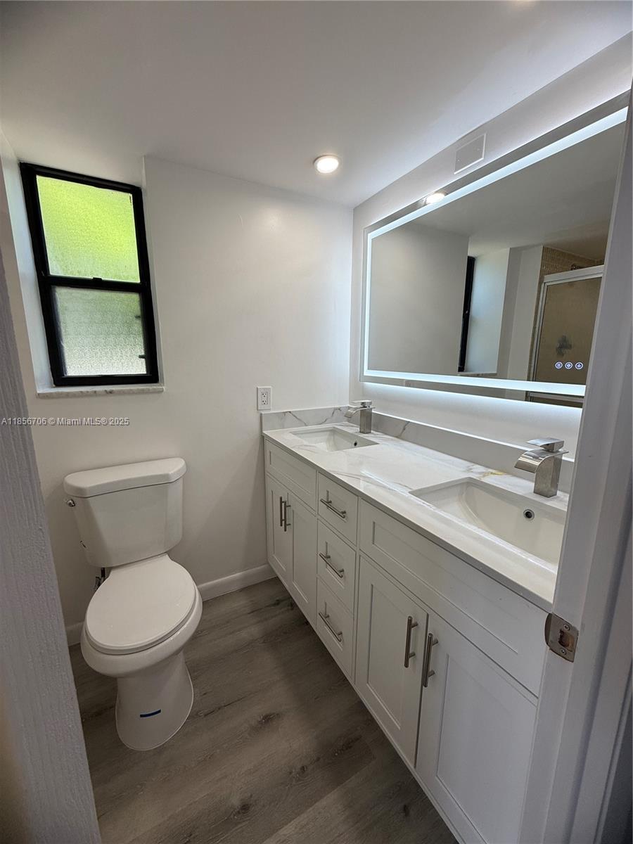 20200 West Country Club Drive, Unit PH14 Aventura, FL 33180 - Photo 13 of 15 a bathroom with a toilet sink and mirror